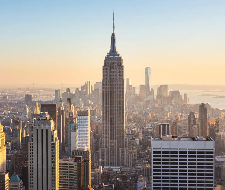 Empire state building with surrounding buildings.