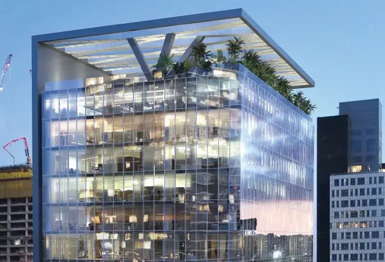 Studio tower lit up with blue sky in background.